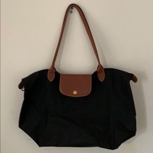 Large, black longchamp bag.